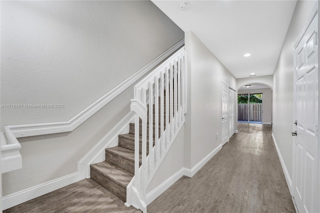 staircase with wood-type flooring