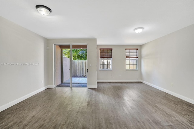 spare room with dark wood-type flooring