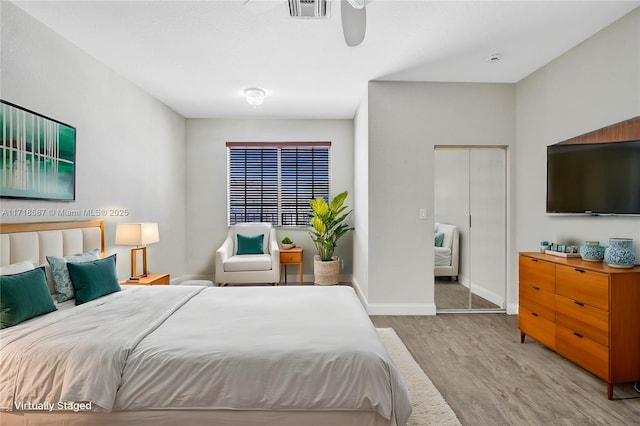 bedroom featuring ceiling fan, a closet, and light hardwood / wood-style floors