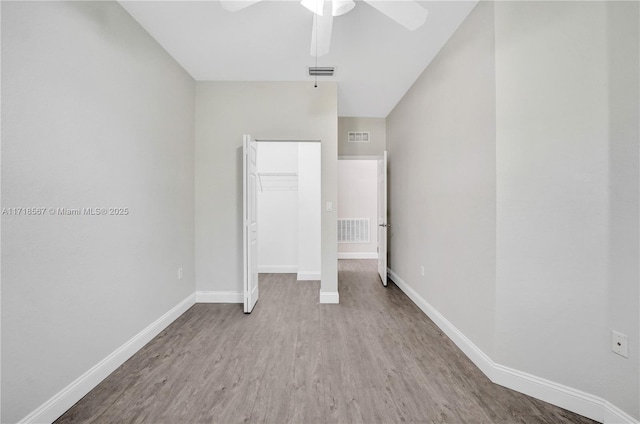 unfurnished bedroom featuring ceiling fan, a closet, and light hardwood / wood-style flooring