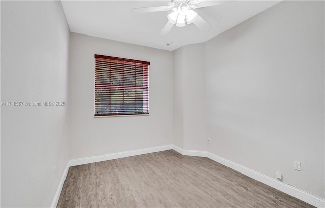 spare room with hardwood / wood-style flooring and ceiling fan