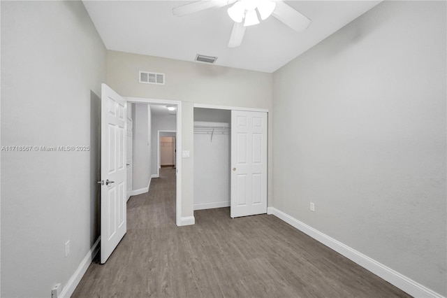 unfurnished bedroom with a closet, hardwood / wood-style flooring, and ceiling fan