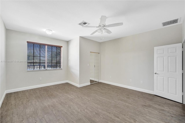 empty room with ceiling fan and hardwood / wood-style floors