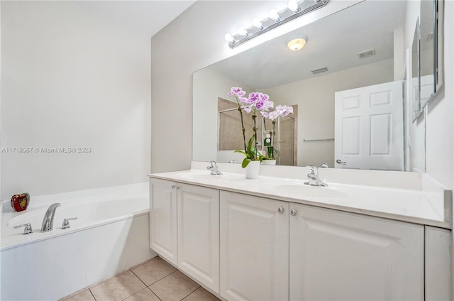 bathroom with tile patterned flooring, vanity, and a tub to relax in