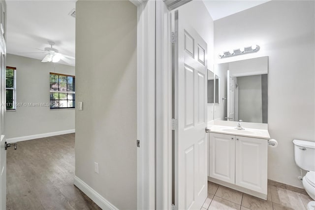 bathroom with ceiling fan, tile patterned flooring, vanity, and toilet