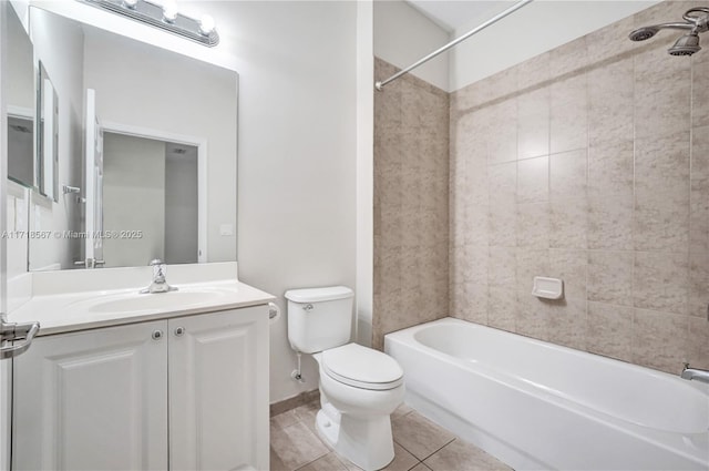 full bathroom with tile patterned flooring, vanity, tiled shower / bath combo, and toilet