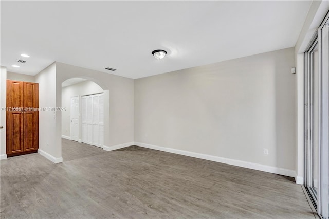 unfurnished room with wood-type flooring