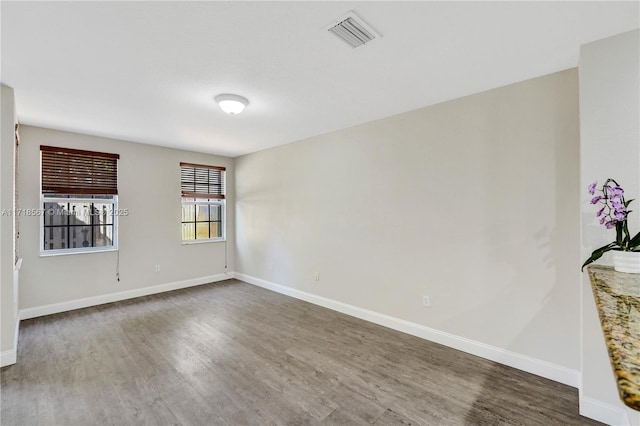 spare room with dark hardwood / wood-style floors