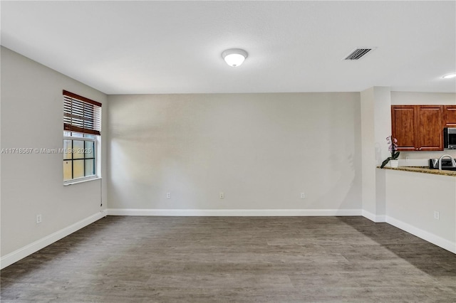 unfurnished room featuring hardwood / wood-style flooring