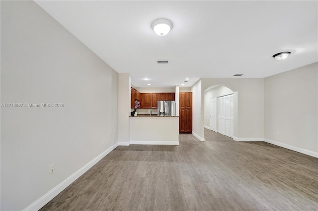 unfurnished living room featuring hardwood / wood-style floors