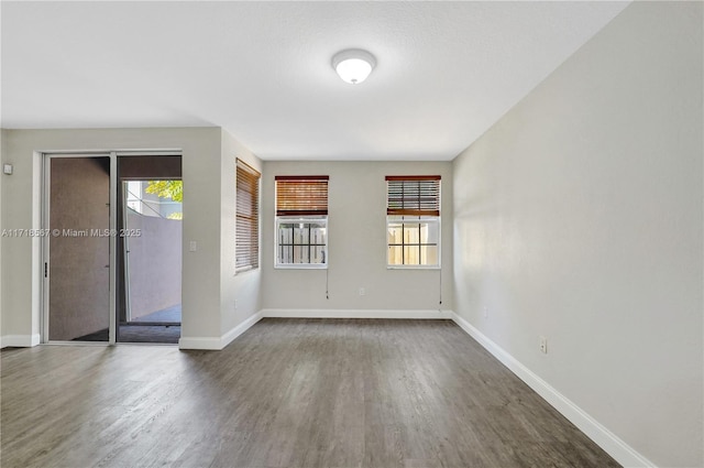 empty room featuring dark hardwood / wood-style flooring