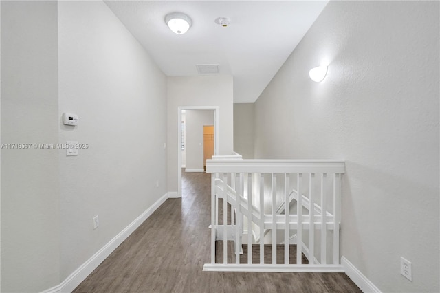 corridor with hardwood / wood-style floors