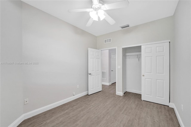 unfurnished bedroom with ceiling fan, a closet, and light wood-type flooring