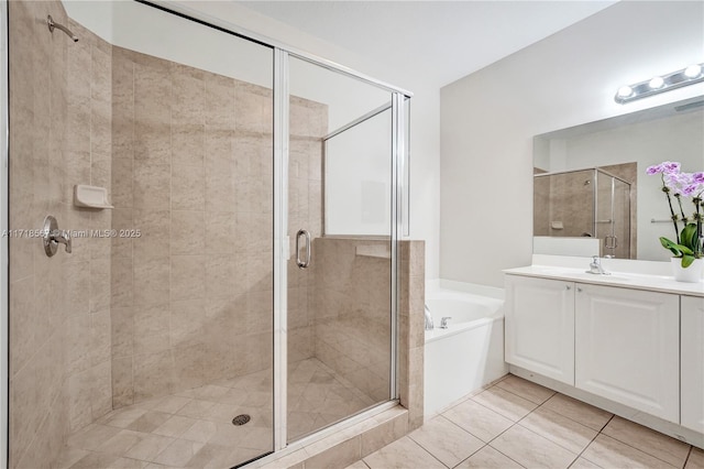 bathroom featuring shower with separate bathtub, vanity, and tile patterned floors