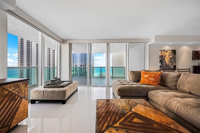 living room featuring tile patterned flooring and a water view