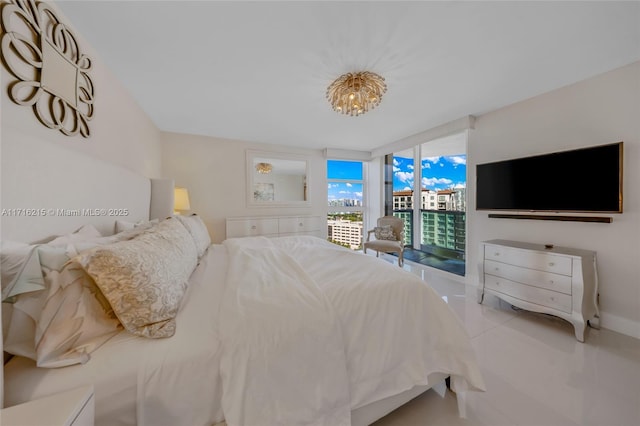 bedroom featuring access to exterior, a chandelier, and floor to ceiling windows