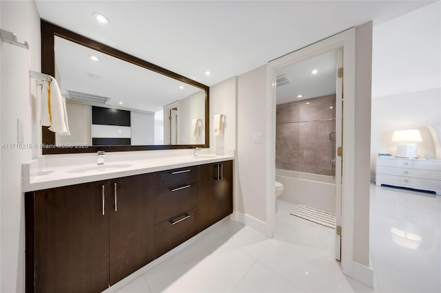 full bathroom with tile patterned flooring, vanity, toilet, and tiled shower / bath combo