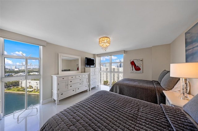 bedroom with access to exterior and a water view