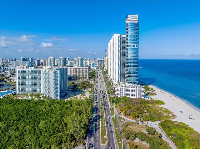 birds eye view of property featuring a water view and a beach view