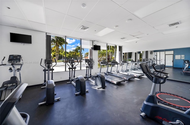 workout area with a paneled ceiling