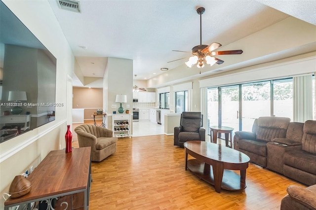 living room with ceiling fan and light wood-type flooring