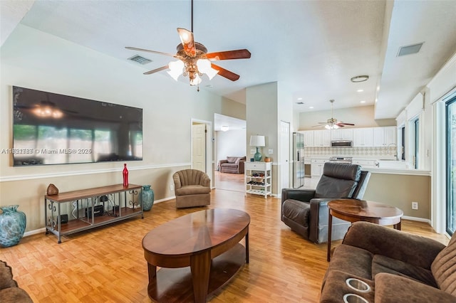 living room featuring ceiling fan and light wood-type flooring