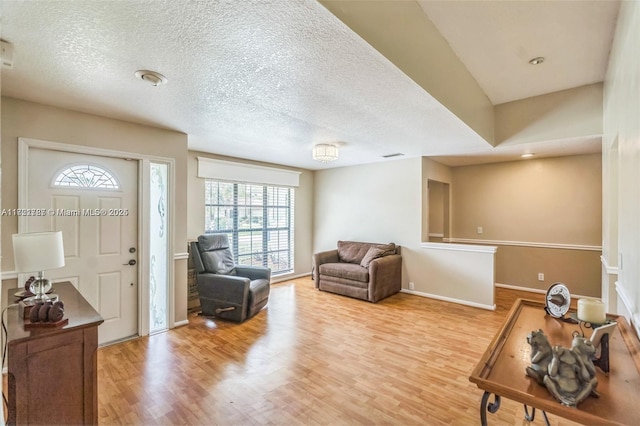 foyer with wood-type flooring and a textured ceiling