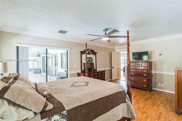 bedroom featuring access to exterior, ceiling fan, light hardwood / wood-style flooring, and a textured ceiling