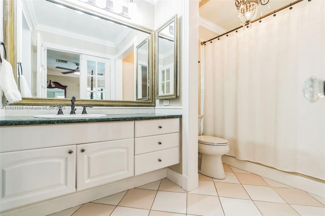 bathroom featuring tile patterned floors, ornamental molding, vanity, a notable chandelier, and toilet