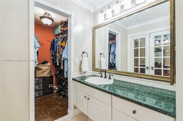 bathroom featuring crown molding and vanity