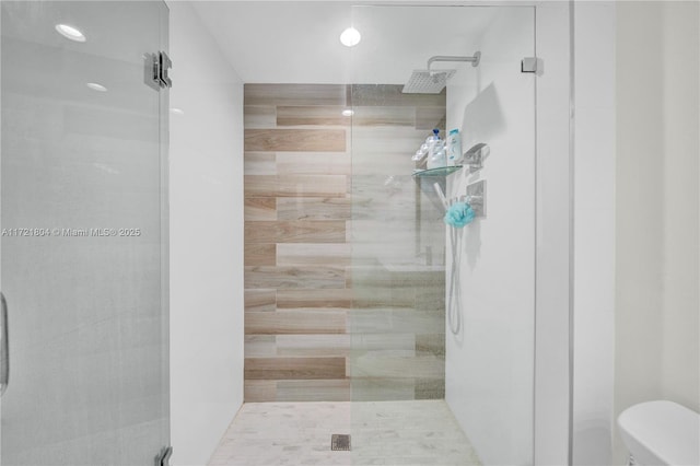 bathroom with toilet and an enclosed shower