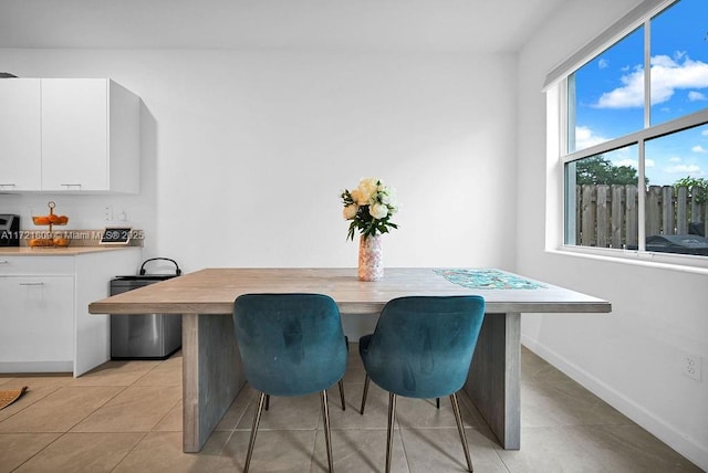 dining space featuring light tile patterned floors