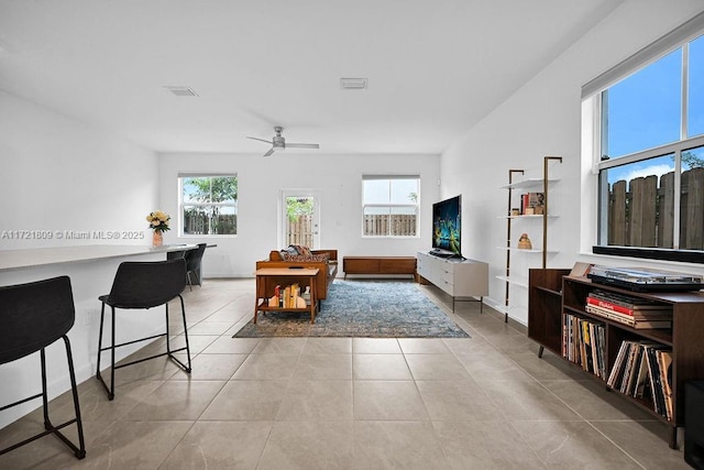 tiled living room with ceiling fan