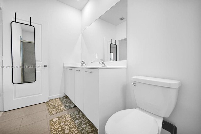 bathroom with tile patterned floors, vanity, and toilet