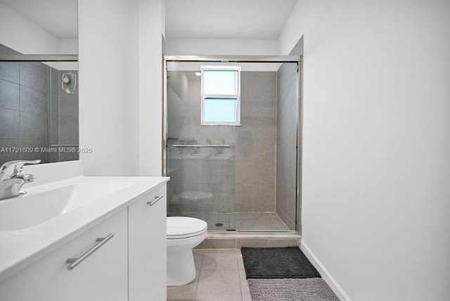 bathroom featuring tile patterned flooring, vanity, toilet, and a shower with shower door