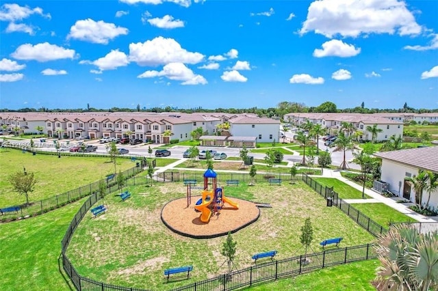 view of home's community featuring a yard and a playground