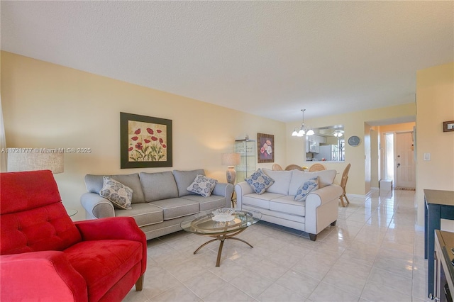 living room featuring a textured ceiling and an inviting chandelier