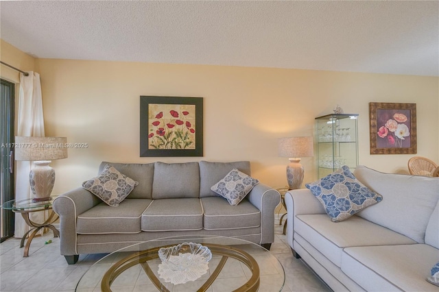 tiled living room featuring a textured ceiling