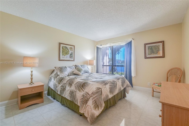 bedroom featuring light tile patterned floors and a textured ceiling