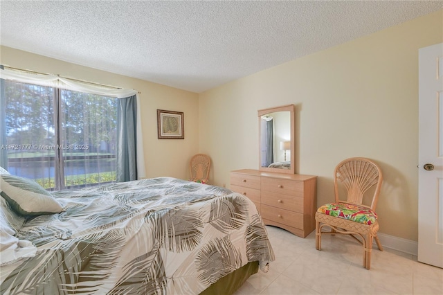 tiled bedroom with a textured ceiling