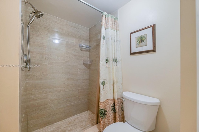 bathroom featuring a shower with curtain and toilet