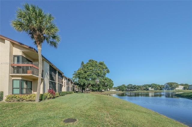 view of home's community featuring a yard and a water view