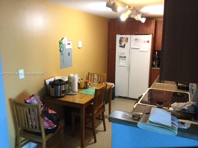 tiled dining room featuring electric panel