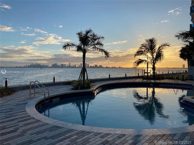 pool at dusk with a water view