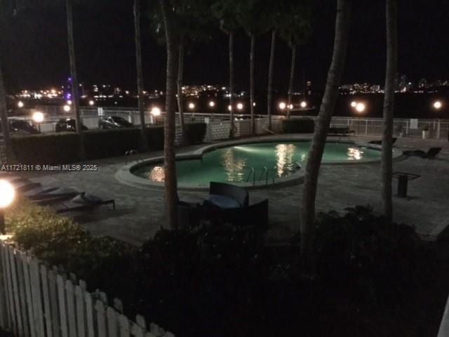 pool at night with a patio