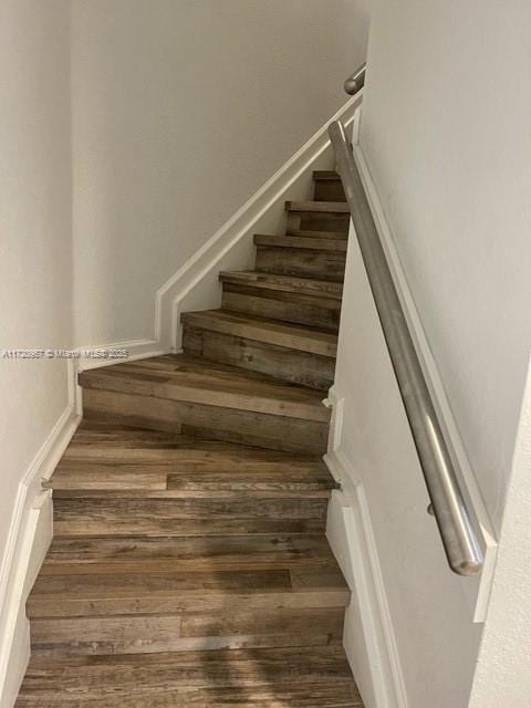 stairway with hardwood / wood-style floors