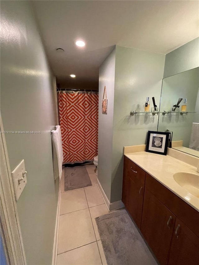 bathroom featuring toilet, vanity, and tile patterned floors