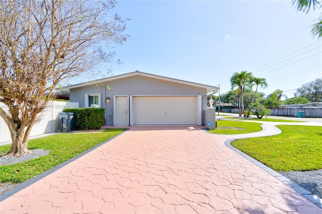 ranch-style home featuring a garage and a front lawn