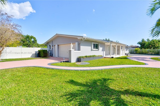 ranch-style house with a garage and a front yard