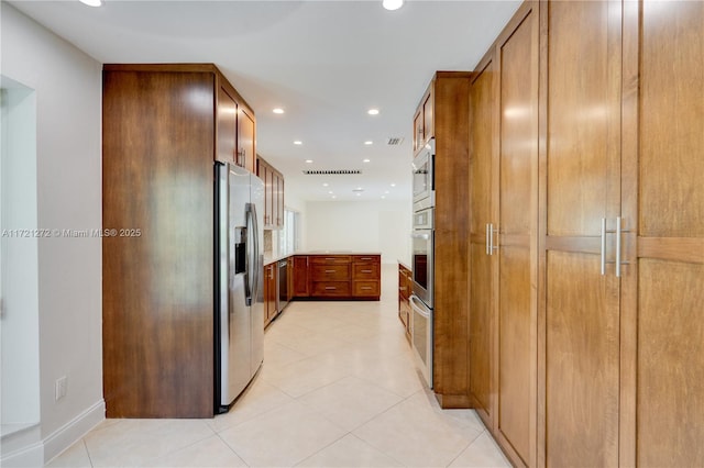 kitchen with light tile patterned floors and appliances with stainless steel finishes